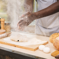 About Us - Black Forest Cake House - Chef making dough in the kitchen